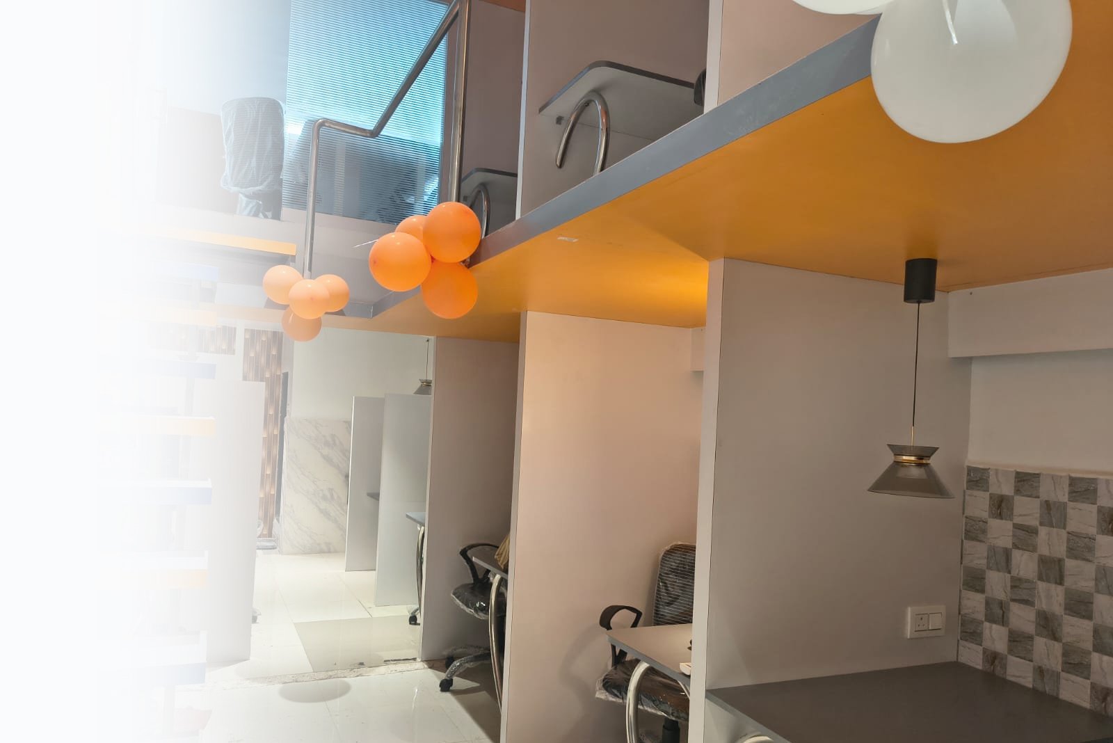 Neel CoHub Sector 19 focus desks with the open staircase and orange ceiling